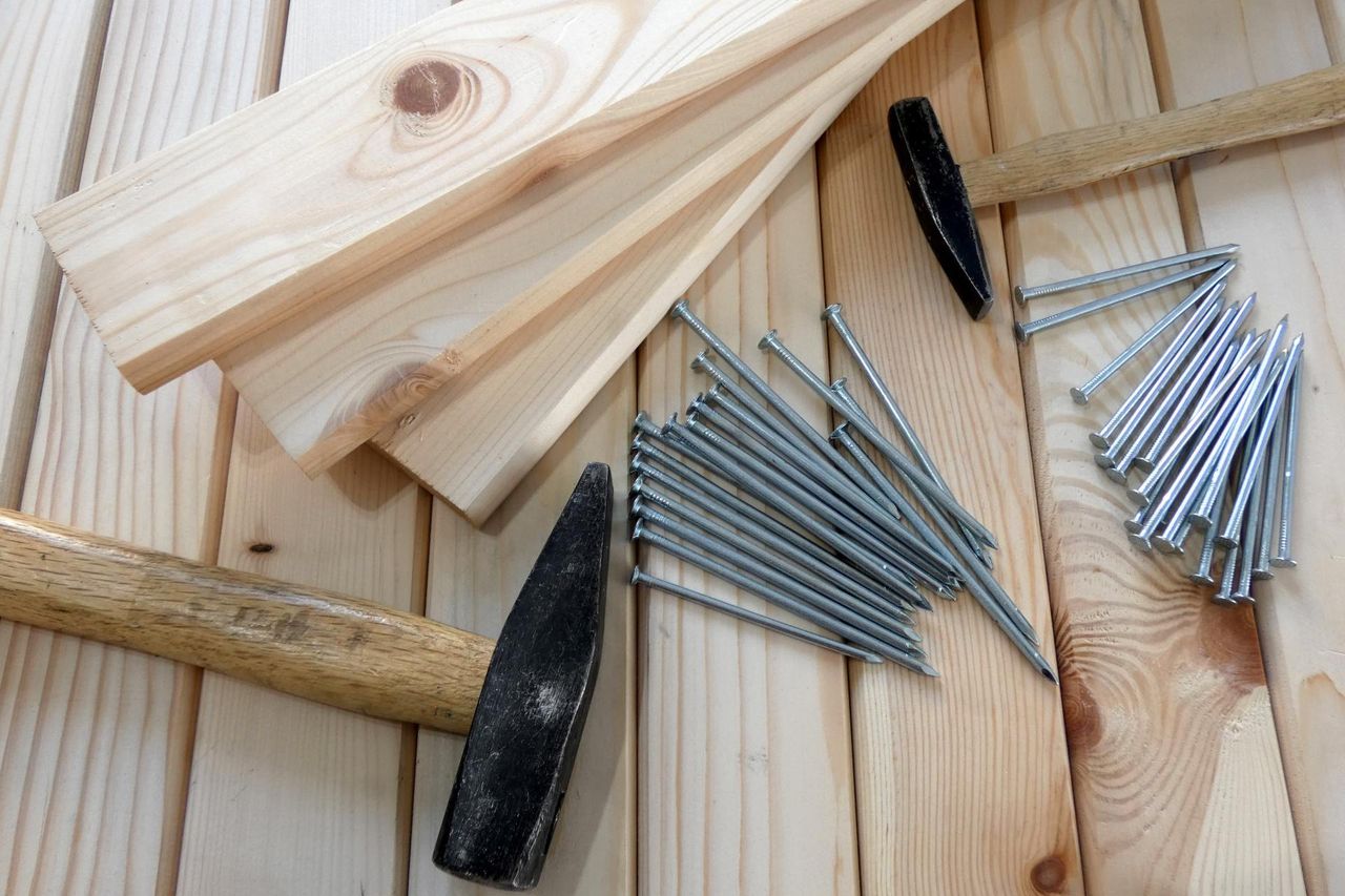 A contractor fastening deck boards with a cordless drill