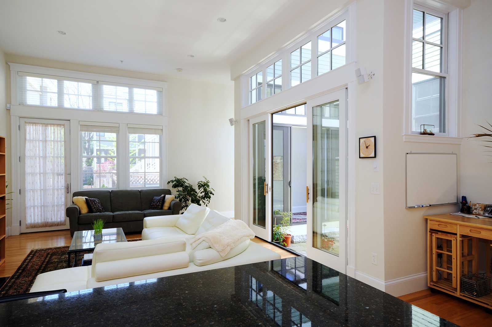 A sunlit living room with large energy-efficient windows
